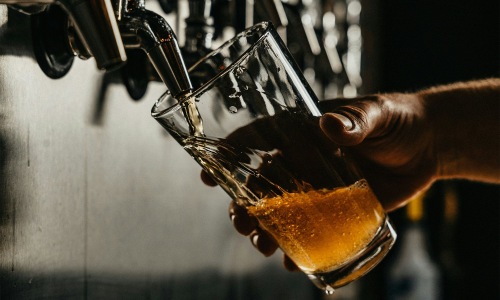 Bustling community with plenty of dining choices someone pouring a glass of beer