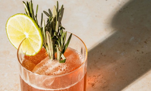 Bustling community with plenty of dining choices a glass with a drink and a lemon on top
