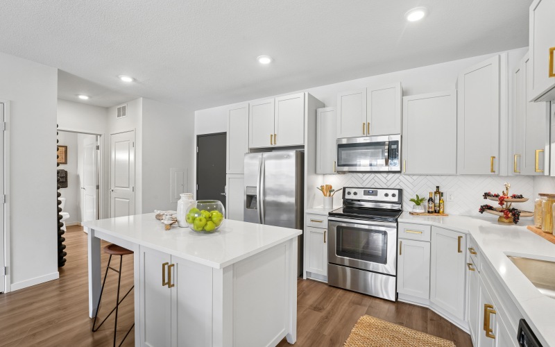 Bright white kitchen with sleek cabinetry and natural light apartments in Brooklyn Park, MN